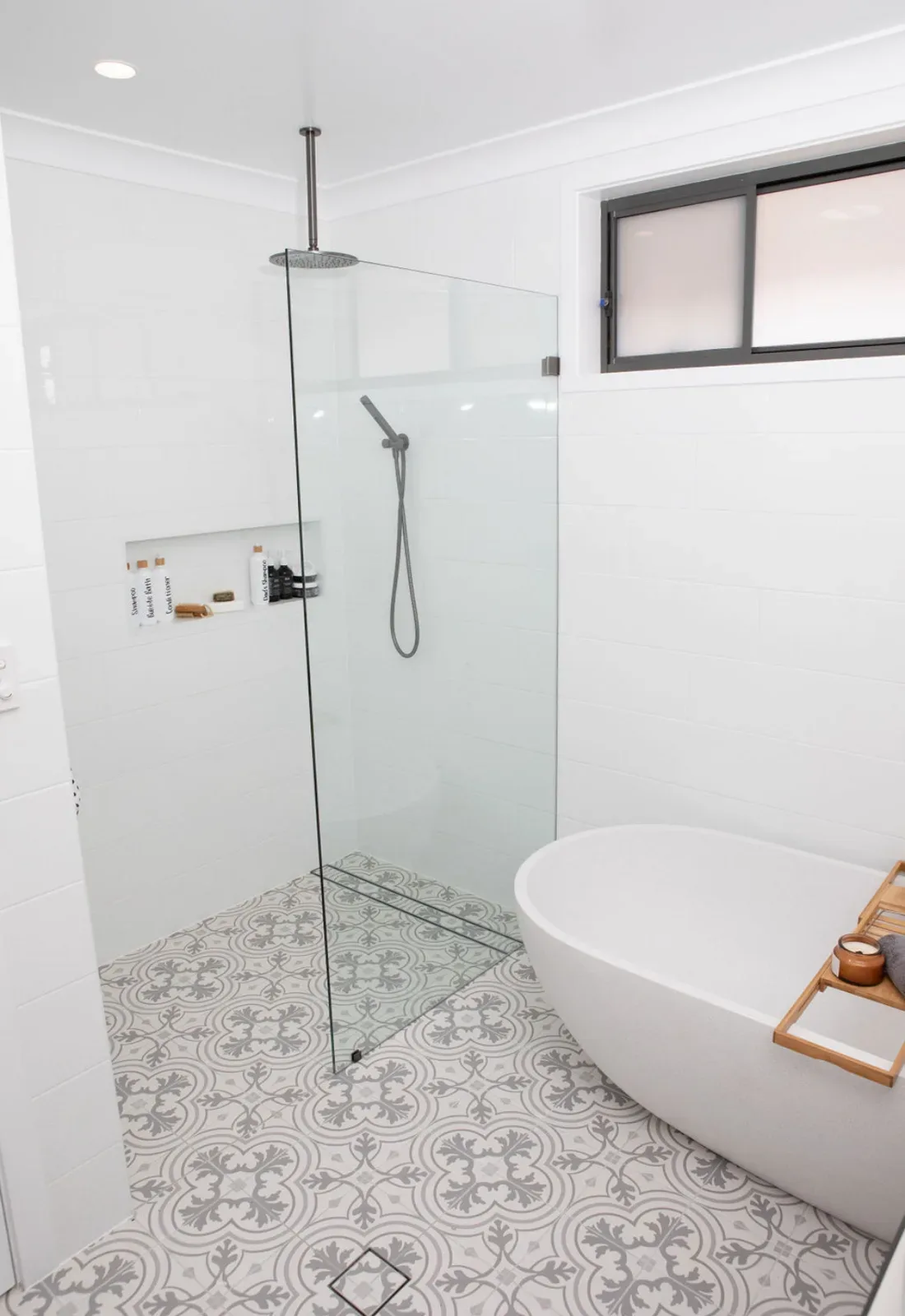 Bathroom renovation with freestanding bath and patterned feature floor