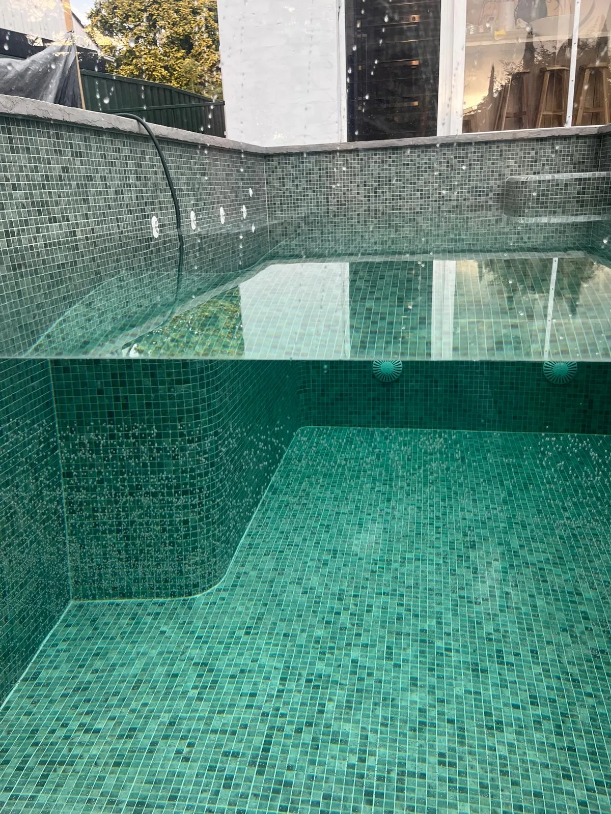 Swimming pool with green mosaic tiles