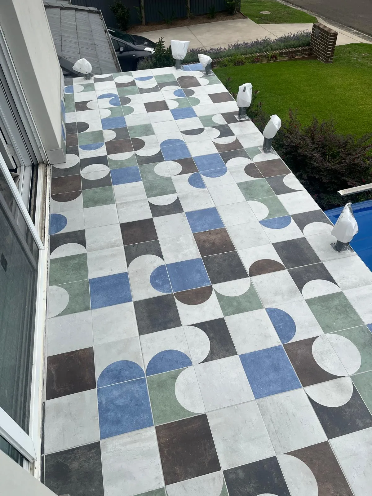 Outdoor patterned tiles beside swimming pool